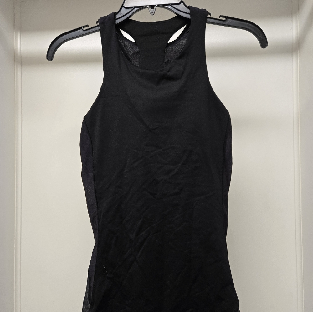 Black racerback Women's yoga tanktop with cutouts and mesh details.
